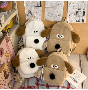 Detail of plush Gromit-style backpacks with soft long fur and bear pendant in warm tones