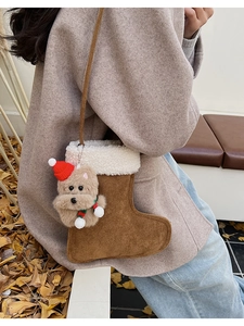 Detail of Christmas stocking crossbody bag with cute teddy bear charm and soft fleece trim