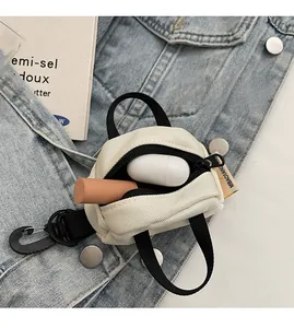 Mini off-white canvas storage pouch showing lipstick and earbud case inside