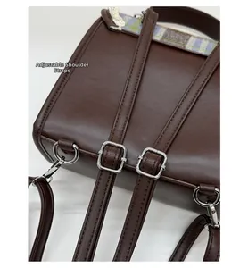 Detail of adjustable leather shoulder straps with metal buckle on plaid kids backpack