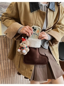 Detail of plush Christmas stocking pouch with cute bear charm and striped phone case