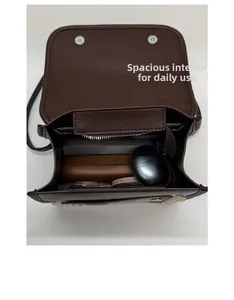 Internal view of a plaid mini shoulder bag showing capacity for phone and accessories