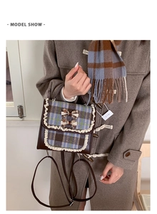 Detail view of vintage plaid kids backpack with lace trim and bow on model outfit