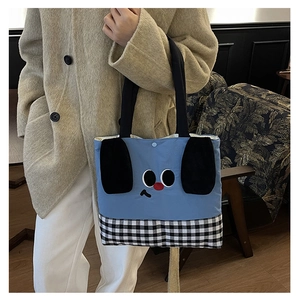 Close-up of blue canvas kids tote bag featuring cute cartoon dog ears and snap closure
