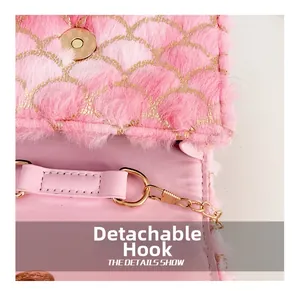 Detail of pink plush fabric with golden embroidery and detachable metal chain hook