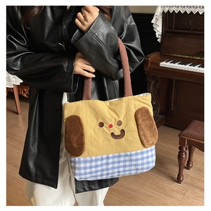 Close-up of cute cartoon tote bag with 3D plush ears and blue checkered pattern for kids