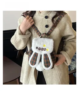 Detail of cute long-eared rabbit backpack featuring brown plaid fabric and white faux fur