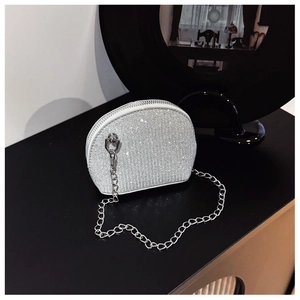 Detail of silver rhinestone shell-shaped evening bag with a metallic chain strap