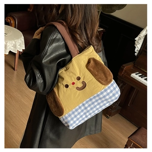 Close-up of cute cartoon dog tote bag with plush ears on child's shoulder in vintage setting