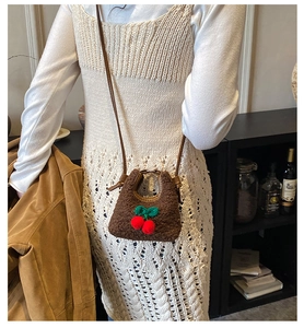 Brown faux shearling mini tote bag with cherry patch shown on a model's shoulder