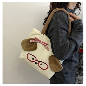 Detail of cute cream canvas tote bag with cartoon dog face and plush ears for children