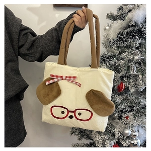 Detail of cute dog pattern on cream canvas tote with plush ears and plaid bow