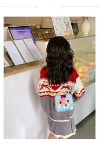 Girl wearing a colorful teddy bear plush bag with pearl handle and gold chain