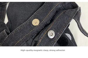 Detail of high-quality magnetic buckle on black denim bucket bag with contrast stitching
