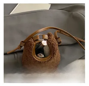Internal capacity of mini plush cherry bucket bag showing lipstick storage details