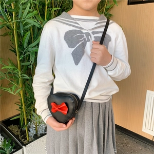 Sweet heart-shaped crossbody bag for girls with a red bow and gold zipper closure
