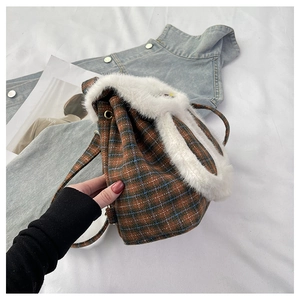 Detail of checkered drawstring backpack with faux fur trim and cute rabbit ear design
