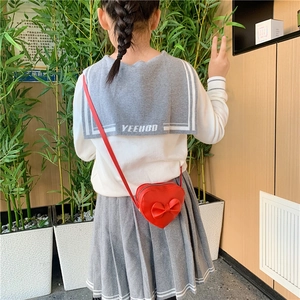 Sweet red heart-shaped girls shoulder bag with bow and minimalist school style outfit