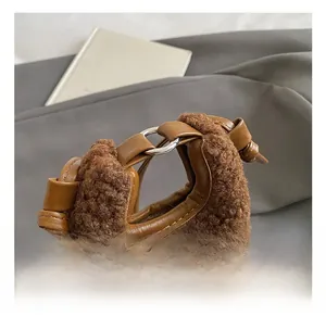 Detail of plush cherry bag featuring premium leather knotted handle and metal rings