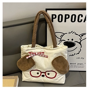 Detail of cute dog canvas tote bag with 3D plush ears and red bow embroidery