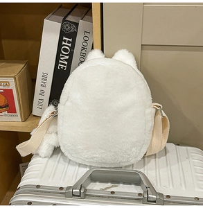 Close-up of white plush cartoon dog bag showing soft faux fur and metallic metal buckles