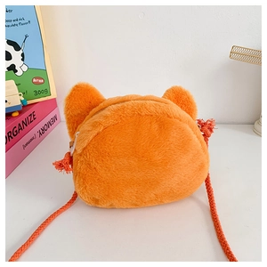 Detail of cute orange plush fox bag with soft texture and durable braided strap for kids
