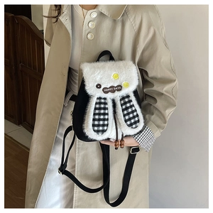 Detail of plush rabbit ears on a black and white checkered backpack with Happy Days tag