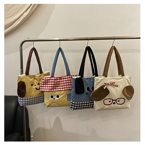 Detail view of cute cartoon dog shoulder bags with plush ears and 3D bowknot accents