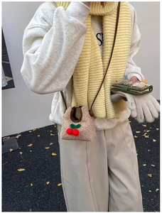Kid's mini cherry shoulder bag in beige fleece shown with winter outfit and ginkgo leaves