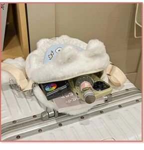 Detail view of large capacity white plush dog bag showing internal storage for essentials