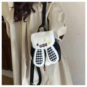 Close-up of cute rabbit ears and Happy Days badge on a plush drawstring mini backpack