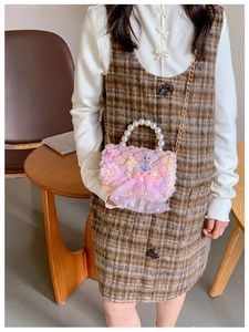 Detailed view of pink plush child handbag with pearl handle and Elsa princess patch