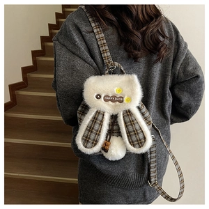 Detail of cute plush bunny backpack with plaid pattern and Happy Days floral patch