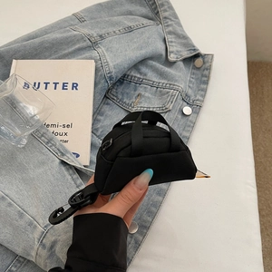 Mini black nylon coin purse shown in hand with zipper and hook for headphone storage