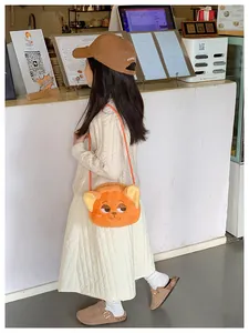 Detail of cute orange plush fox bag for kids with embroidered facial features and ears