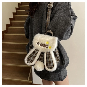Detail of cute plush bunny backpack with checkered fabric and Happy Days patch