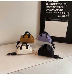 Mini canvas keychain bags in yellow, purple, white, and black with durable plastic hooks