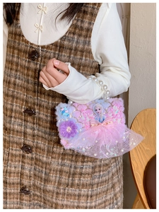 Detailed shot of kids plush handbag with pearl handle and cartoon princess design