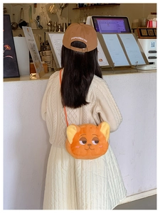 Detail view of a cute orange plush fox shoulder bag for children with embroidery