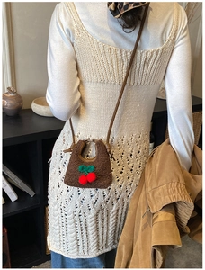 Mini plush cherry crossbody bag for children shown on a model in a lifestyle setting