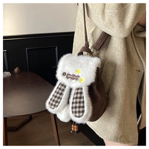 Detail of cute plush bunny backpack with HAPPY DAYS patch and brown checkered ears