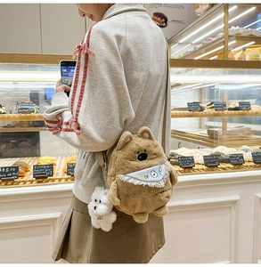 Detail of kids brown plush bear crossbody bag with lace bib and cute puppy charm