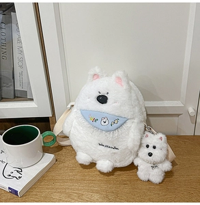 Close-up of fluffy white plush puppy bag with blue lace collar and matching pendant