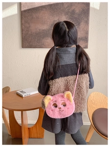 Pink plush cartoon animal crossbody bag for toddlers shown on a young girl model