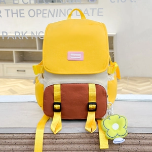 Détail du sac à dos scolaire coloré avec pendentif fleur et écusson de marque