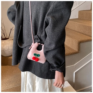 Close-up of pink plush cherry shoulder bag for kids with cute cherry embroidery detail