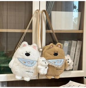 Detailed view of plush animal shoulder bags with blue lace bibs and cute charms