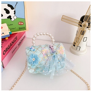 Detail of plush blue kids bag featuring Elsa character and elegant pearl handle