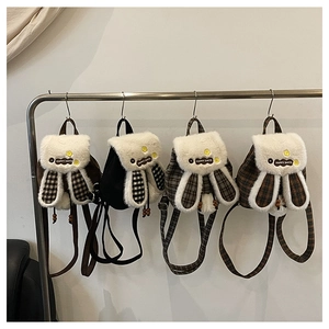 Detail view showing four variants of plush bunny ear backpacks in solid and plaid patterns