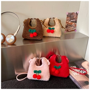 Mini plush cherry crossbody bags in diverse colors displayed on a modern metal rack